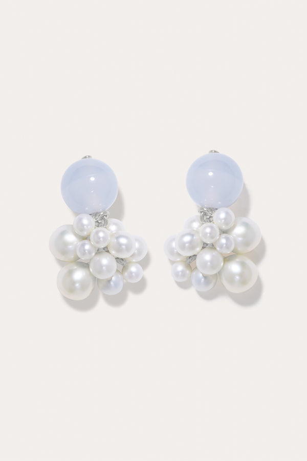 A pair of earrings featuring pearl and blue lace agate with recycled silver.